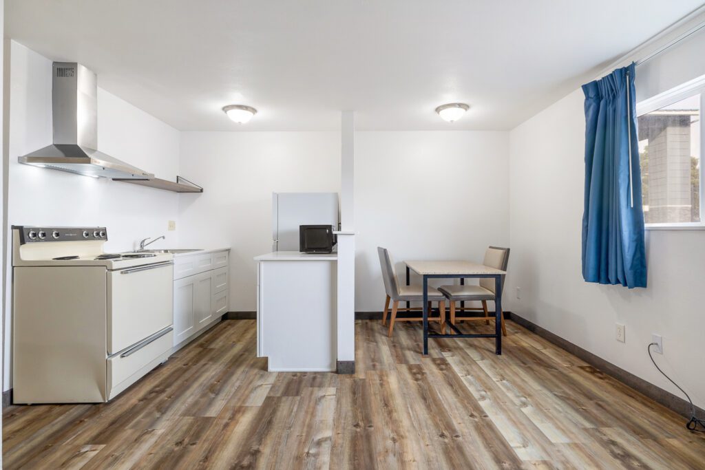 Hotel room kitchen and dining area at Kennewick Inn & Suites Tri Cities with appliances and dining table.