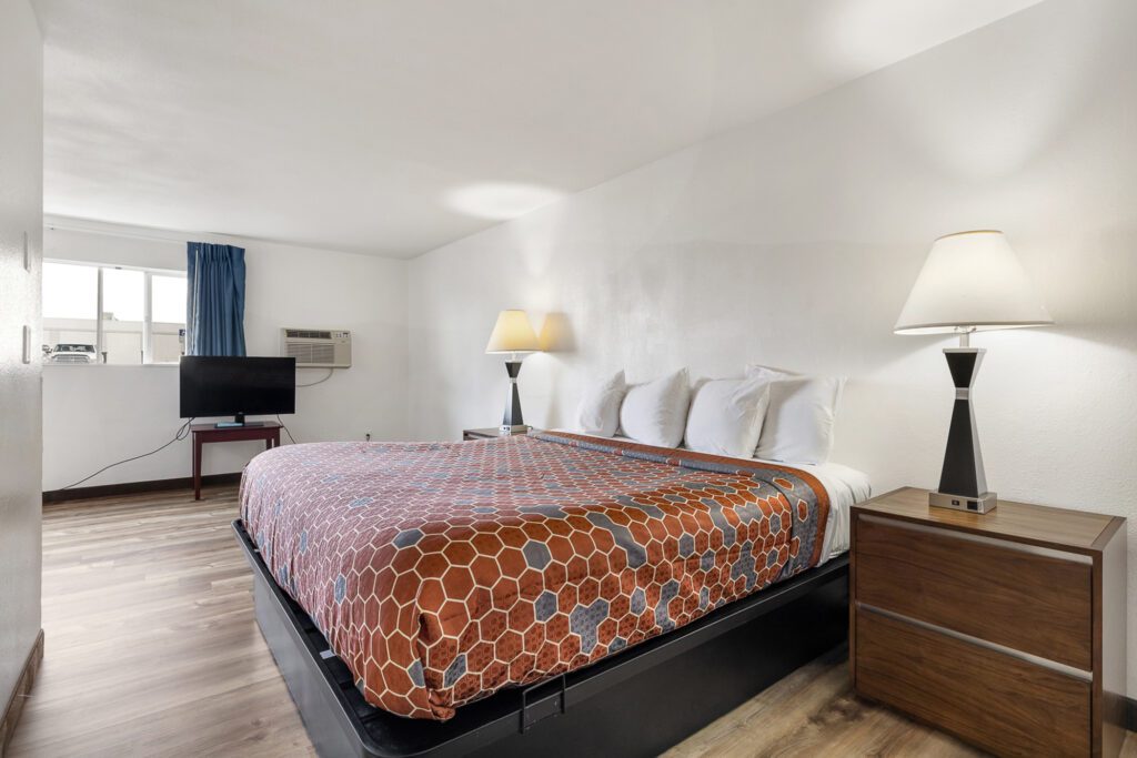 Hotel room at Kennewick Inn & Suites Tri Cities with one king bed and an in-room kitchen.