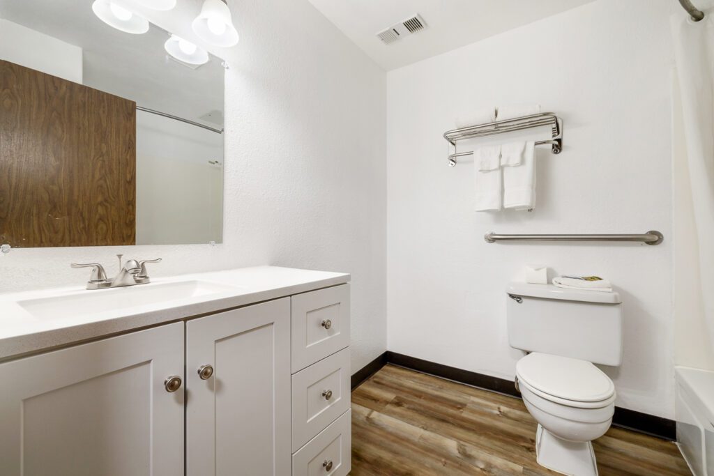 ADA-compliant bathroom at Kennewick Inn & Suites Tri Cities with sink, toilet, and bathtub.