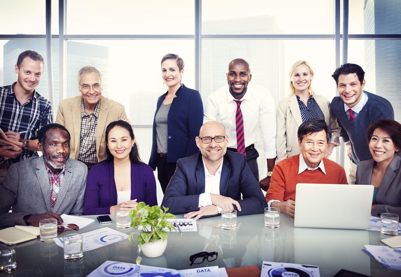 Business people in a conference room posing together