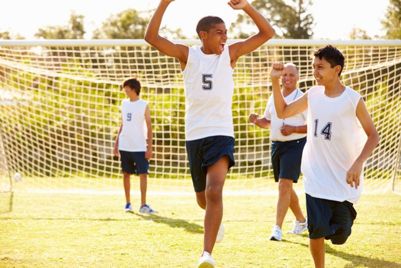 Soccer team celebrating in practice